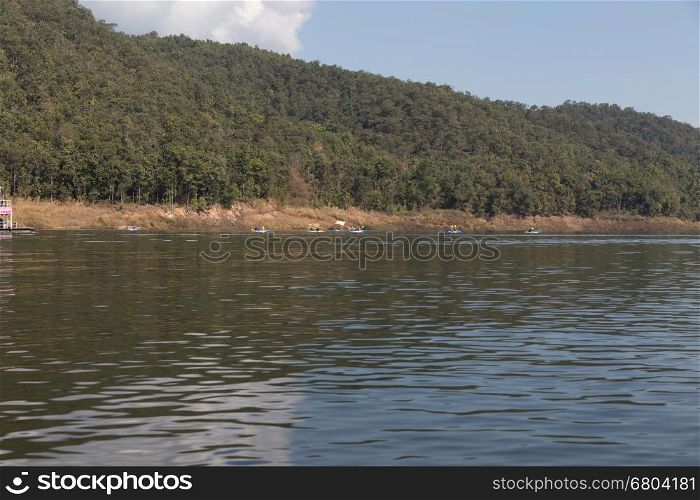 Chiang Mai, Thailand - December 27, 2016: Tourists kayaking on lake in the mountains at Mae Ngad Dam and Reservoir in Chiang Mai, Thailand on December 27, 2016