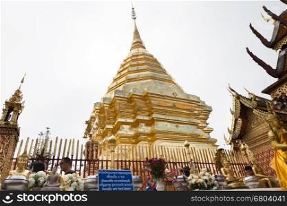 Chiang Mai, Thailand - December 3, 2016: people pay respect to golden pagoda at Wat Phra That Doi Suthep, popular historical temple for traveling attraction in Chiang Mai, Thailand on December 3, 2016.