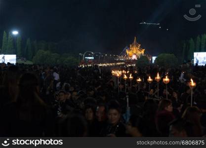 Chiang Mai, Thailand - November 2, 2016: Thai mourners hold candles and pray for the late King Bhumibol Adulyadej at Royal Park Rajapruek, Chiang Mai, Thailand on November 2, 2016.