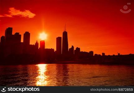 Chicago at sunset skyline across Lake Michigan.