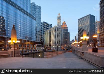 Chicago, Illinois, United States - A view of Chicago River, riverwalk and office buildings at downtown.