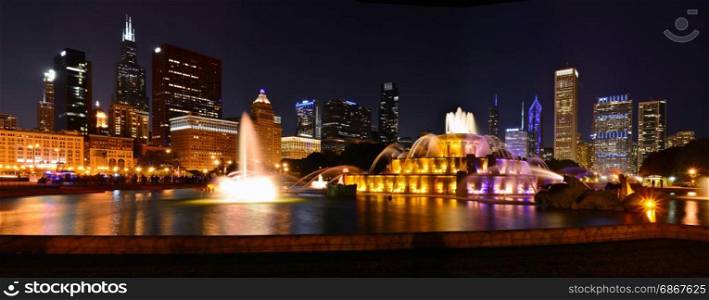Chicago skyline panorama with skyscrapers and Buckingham fountain at night.