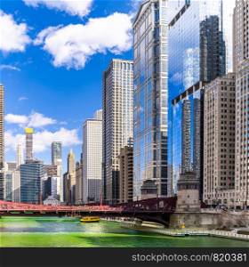 Chicago Skylines building along green dyeing river of Chicago River on St. Patrick day festival in Chicago Downtown IL USA