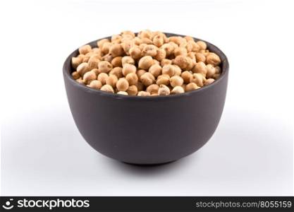 Chick-pea in black bowl. Beans isolated on a white background. Close-up.