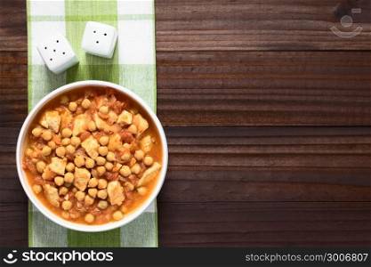 Chicken and chickpea stew or tagine in white bowl, photographed overhead with natural light. Chicken and Chickpea Stew or Tagine