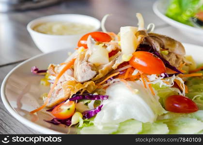 chicken and fresh vegetable salad served with creamy sauce in bowl