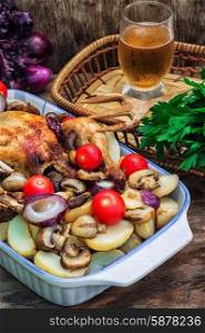 chicken baked with mushrooms,potatoes and vegetables in glass form.Selective focus