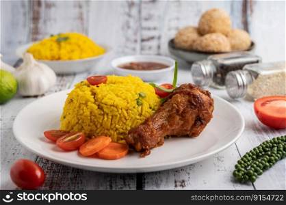 Chicken Biryani in a plate with spices on a white wooden floor