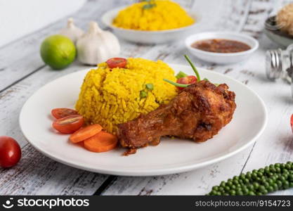 Chicken Biryani in a plate with spices on a white wooden floor