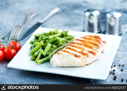 chicken breast and fried green beans on plate