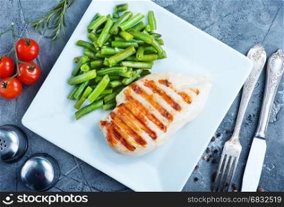 chicken breast and fried green beans on plate