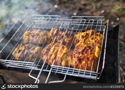 chicken breast grilled on a coals.