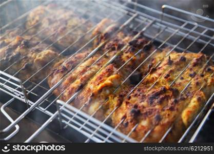 chicken breast grilled on a coals.