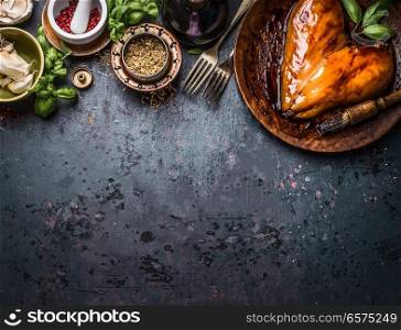 Chicken breast meat in heart shape for cooking or grill on rustic dark country table background with ingredients: herbs, spices and sauce, top view with copy space. Best protein fitness and diet  food