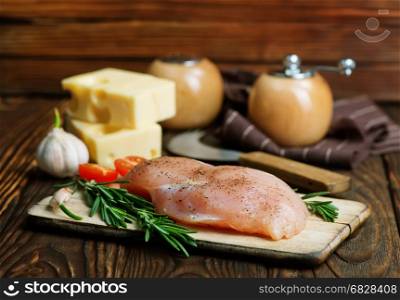 chicken breast on board and on a table