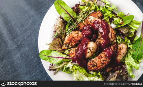 Chicken breast on fresh salad on a background