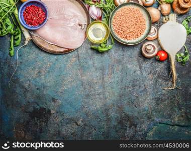 Chicken breast, red lentil, fresh vegetables and various ingredients for cooking on rustic background, top view. Horizontal border. Healthy food, diet or clean eating concept