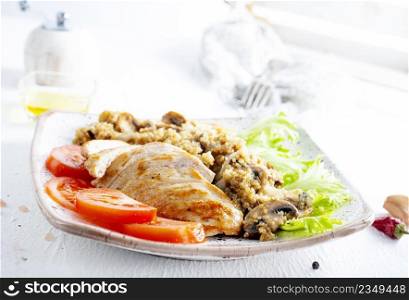 Chicken breast with fried mushrooms on plate