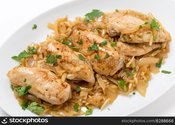 Chicken breasts in an almond, onion and wine sauce, garnished with flat-leaf parsley