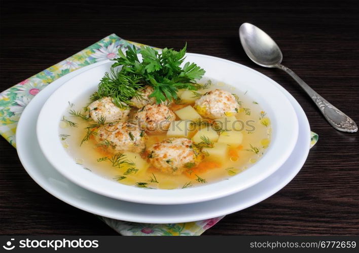 chicken broth of potatoes, carrots and meatballs sprinkled with dill