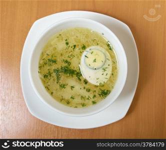 Chicken broth with dill and egg.closeup
