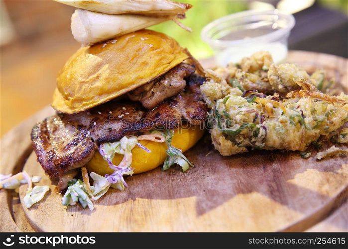 Chicken burger with fried vegetables and wasabi sauce