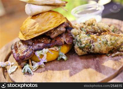 Chicken burger with fried vegetables and wasabi sauce