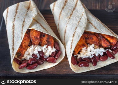 Chicken burritos on the wooden board