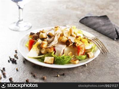 Chicken Caesar salad on the white plate. fresh salad.