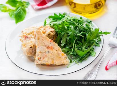 Chicken casserole with vegetables served with green salad, selective focus