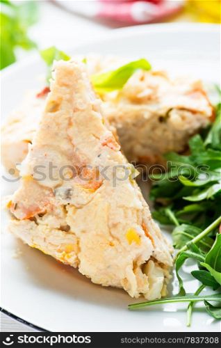 Chicken casserole with vegetables served with green salad, selective focus, closeup
