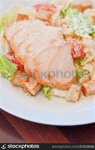 Chicken ceasar salad closeup photo. Chicken ceasar salad
