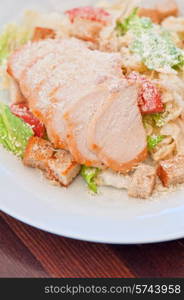 Chicken ceasar salad closeup photo. Chicken ceasar salad