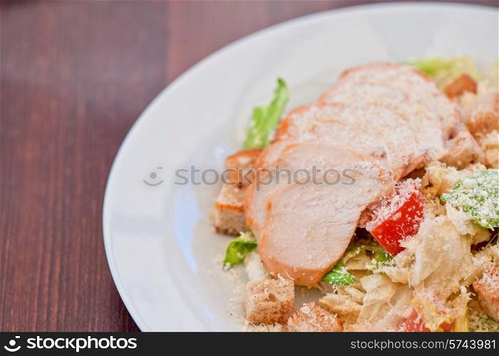 Chicken ceasar salad closeup photo. Chicken ceasar salad