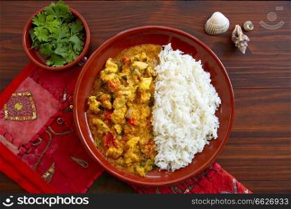 Chicken curry dish indian recipe on dark wood table