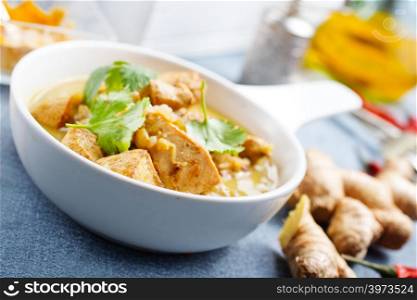 chicken curry in white bowl on a table