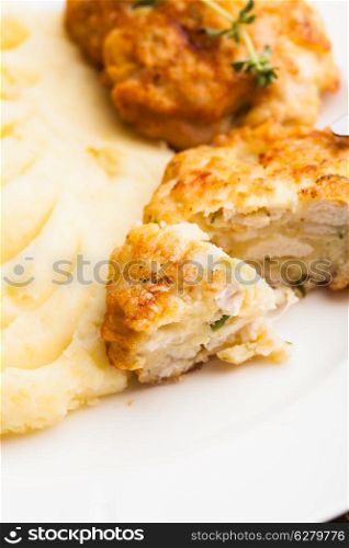 Chicken cutlets and potato puree in a plate close up