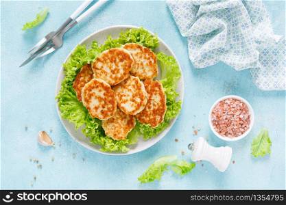Chicken cutlets with fresh lettuce salad on plate