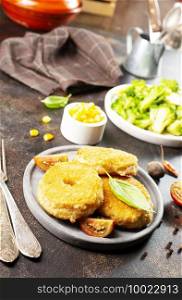 chicken cutlets with vegetables on gray plate