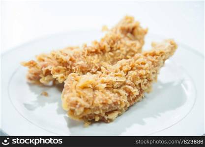 Chicken Deep fried. Placed on a white plate. Fried chicken pieces and variety.