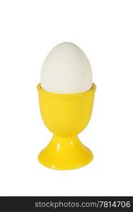 Chicken egg in yellow support on the white background