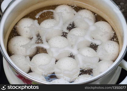 Chicken eggs are boiled in a pan, close-up