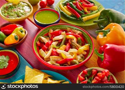 Chicken fajitas with mexican food guacamole pico de gallo chili peppers sauce and nachos
