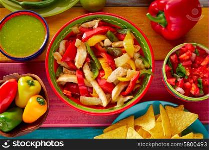 Chicken fajitas with mexican food guacamole pico de gallo chili peppers sauce and nachos