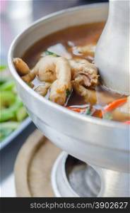chicken feet soup. sour and spicy chicken feet soup in hot bowl
