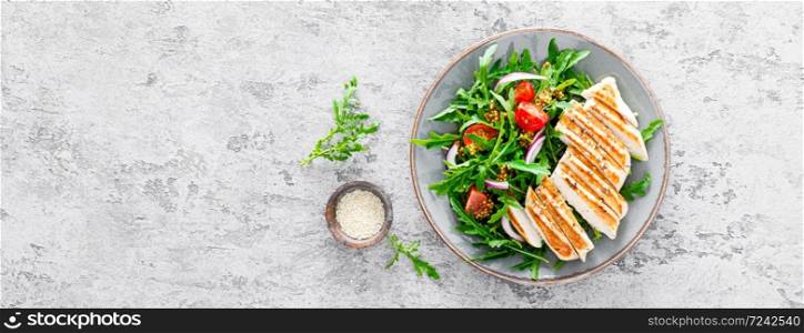 Chicken fillet salad with fresh vegetables and arugula. Fresh vegetable salad of arugula, tomatoes, onion and grilled chicken breast. Banner