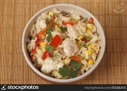 Chicken fried rice, containing capsicum, rice, garlic, egg, in a bowl from above