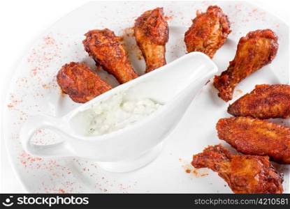 chicken grilled wings with sauce closeup at white plate