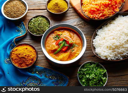 Chicken Jalfrazy indian food recipe with spices and rice on wood