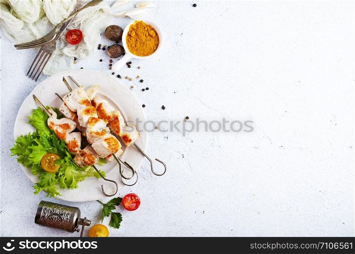 chicken kebab on plate on a table